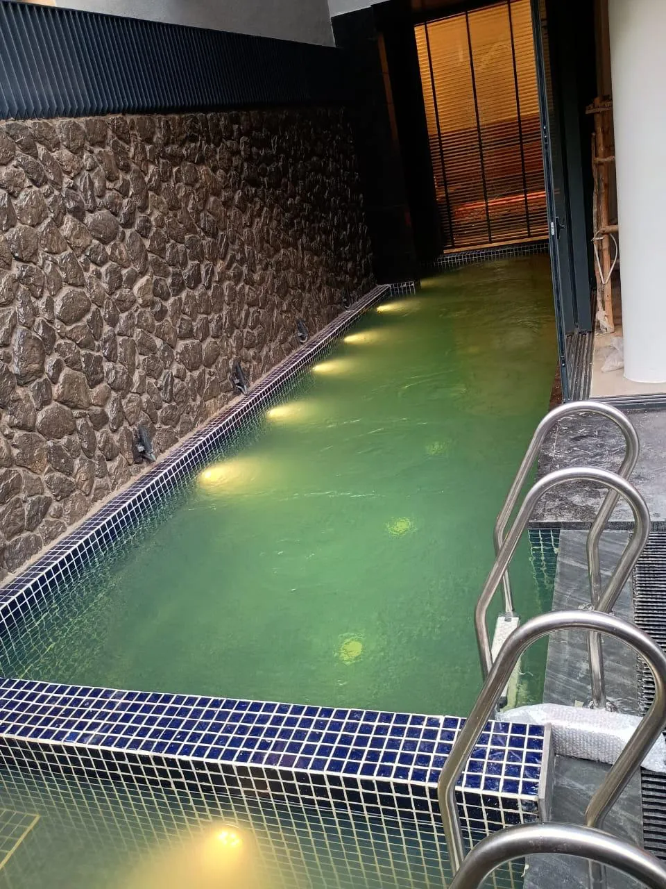 Indoor pool with adjoining sauna and spa deck