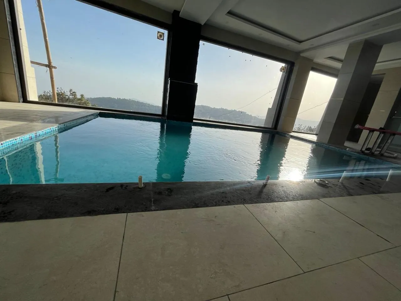 Semi-indoor swimming pool with full-height glazing, Solan Himachal Pradesh